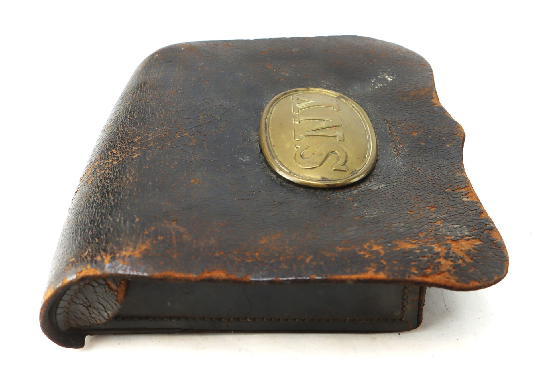 A worn, brown leather pouch with a brass oval emblem marked "SNY" on the flap, showing visible signs of age and use.