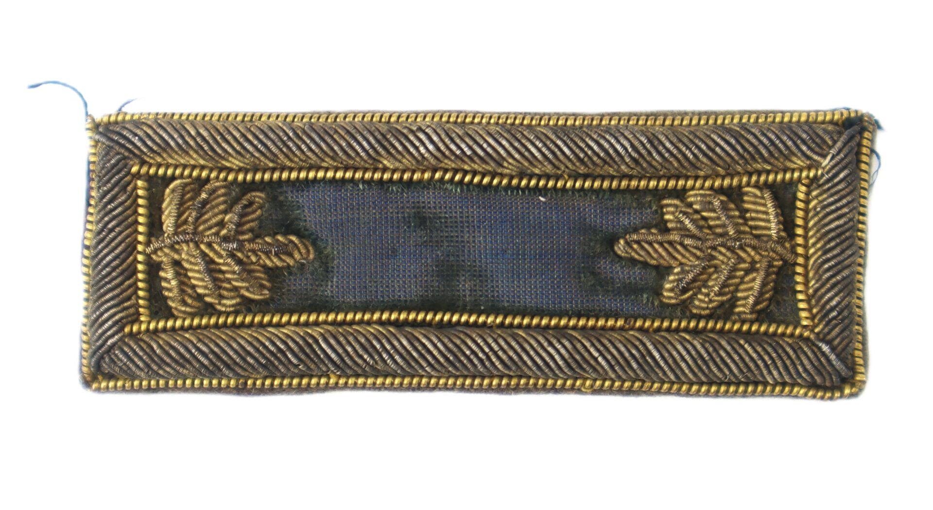 A rectangular military rank insignia with a dark center, gold and silver embroidery, and two gold oak leaf clusters at each end.