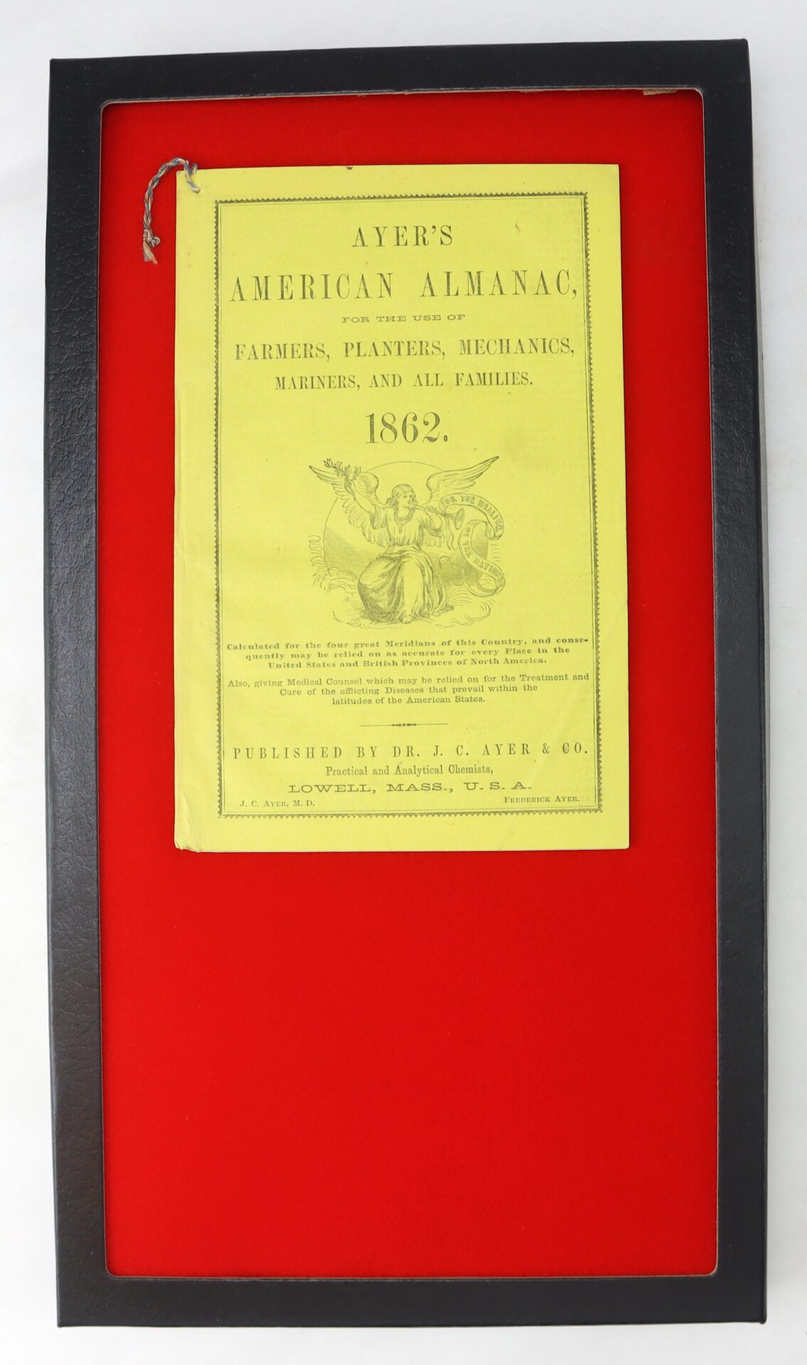 A framed 1862 edition of "Ayer's American Almanac" with a yellow cover, displayed on a red background.