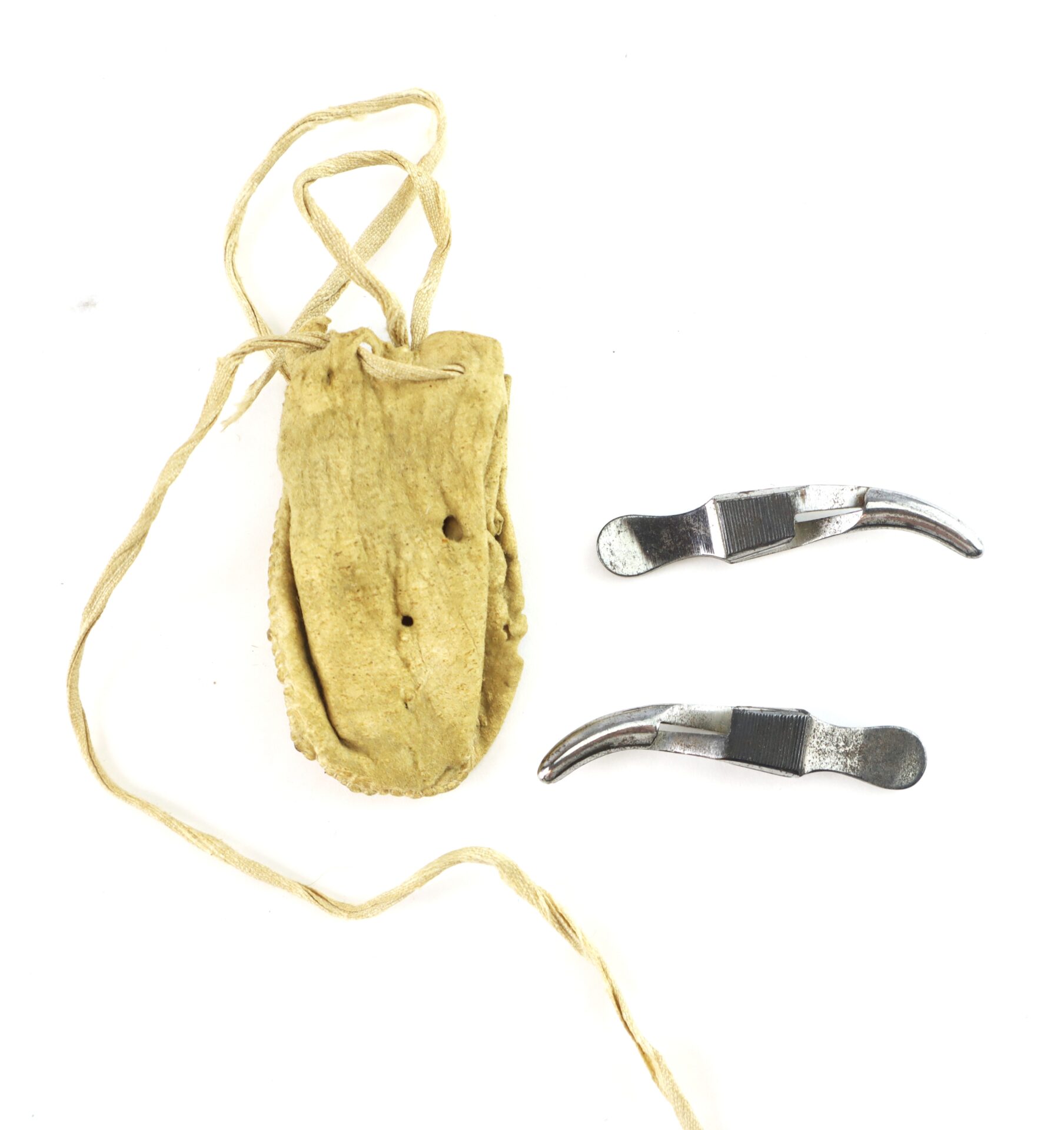 A small tan pouch with a drawstring beside two metal dental tools with curved, flat ends, displayed on a white background.