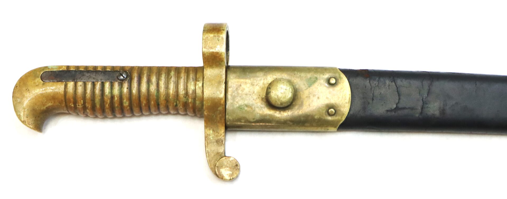 Close-up of an antique brass-handled bayonet with a curved guard and a portion of its black scabbard visible.
