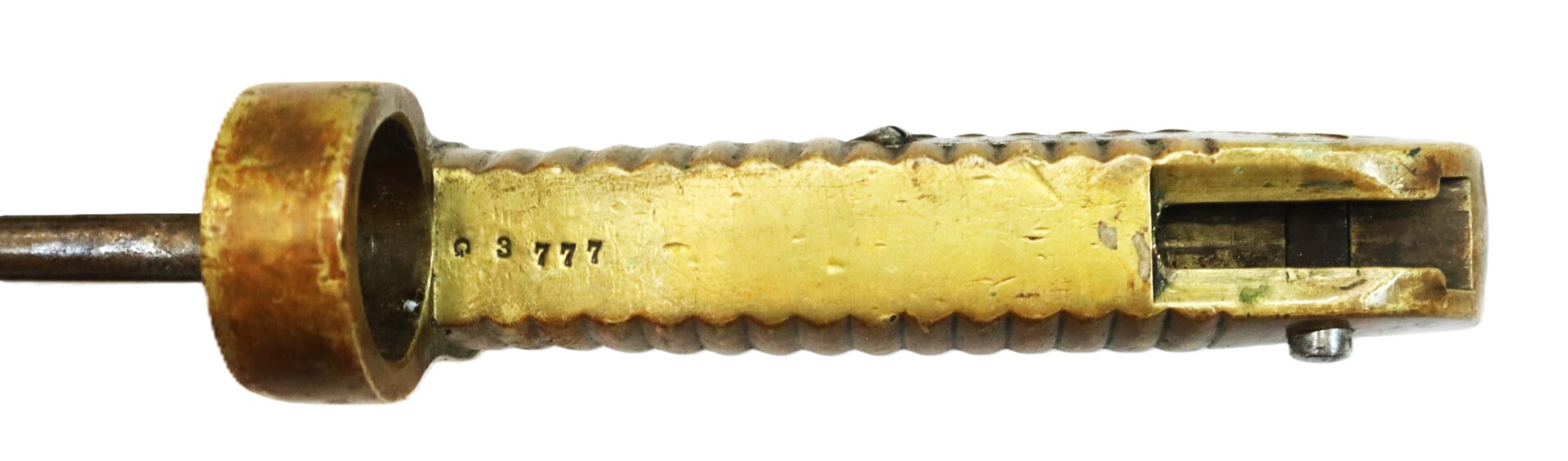 Close-up view of a brass mechanical component with a grooved handle, visible screw, and engraved numbers "3777" on its surface.