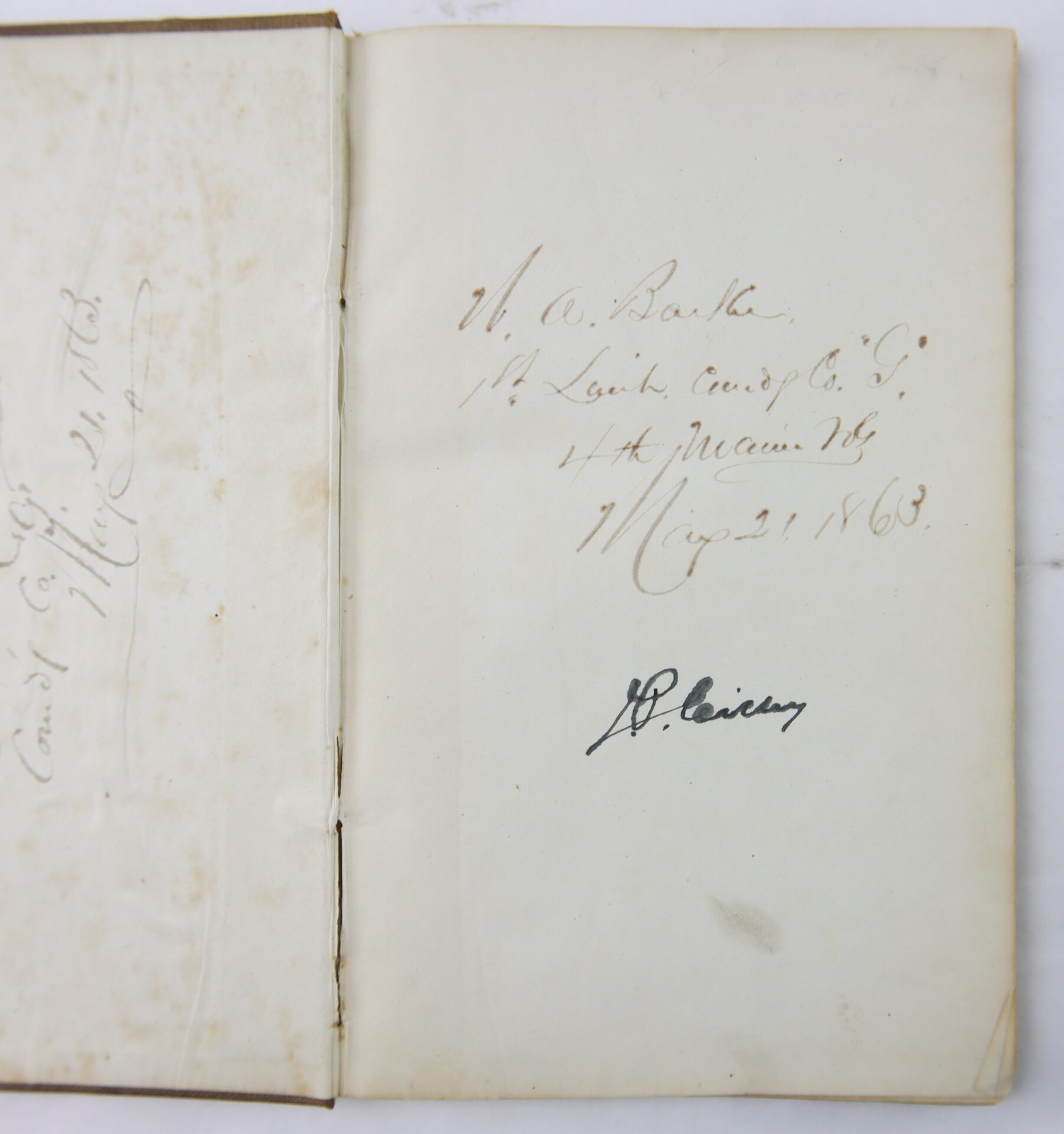 An open book, the 1863 Ordnance Bureau Manual identified to William A. Barker of the 4th Maine Volunteer Infantry, showing handwritten inscriptions and dates from 1863.