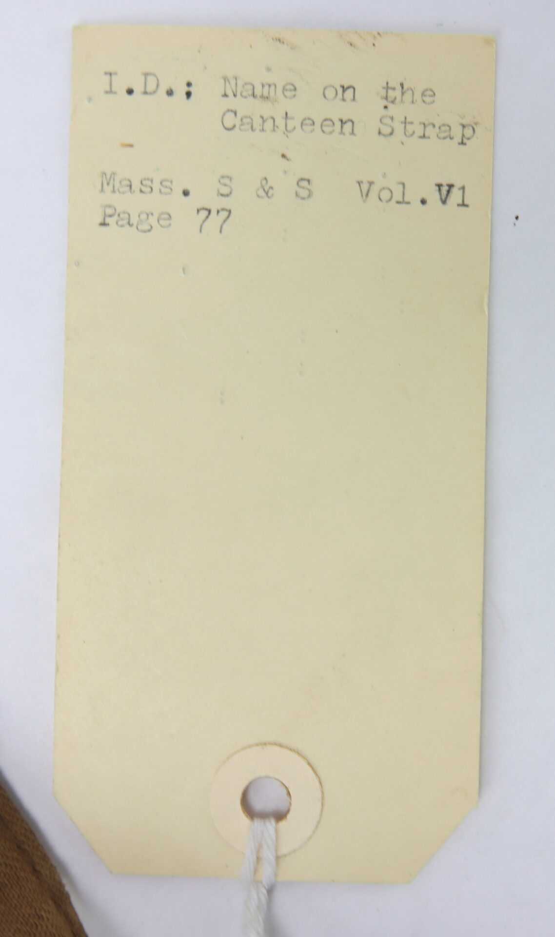 A beige tag with typewritten text—"I.D.; Name on the Canteen Strap. Mass. S & S Vol. VI Page 77"—and a string, accompanies the Outstanding Identified Massachusetts Heavy Artillery Canteen of Benjamin D. Reed, 30th Unattached Co., Mass. Heavy Artillery.