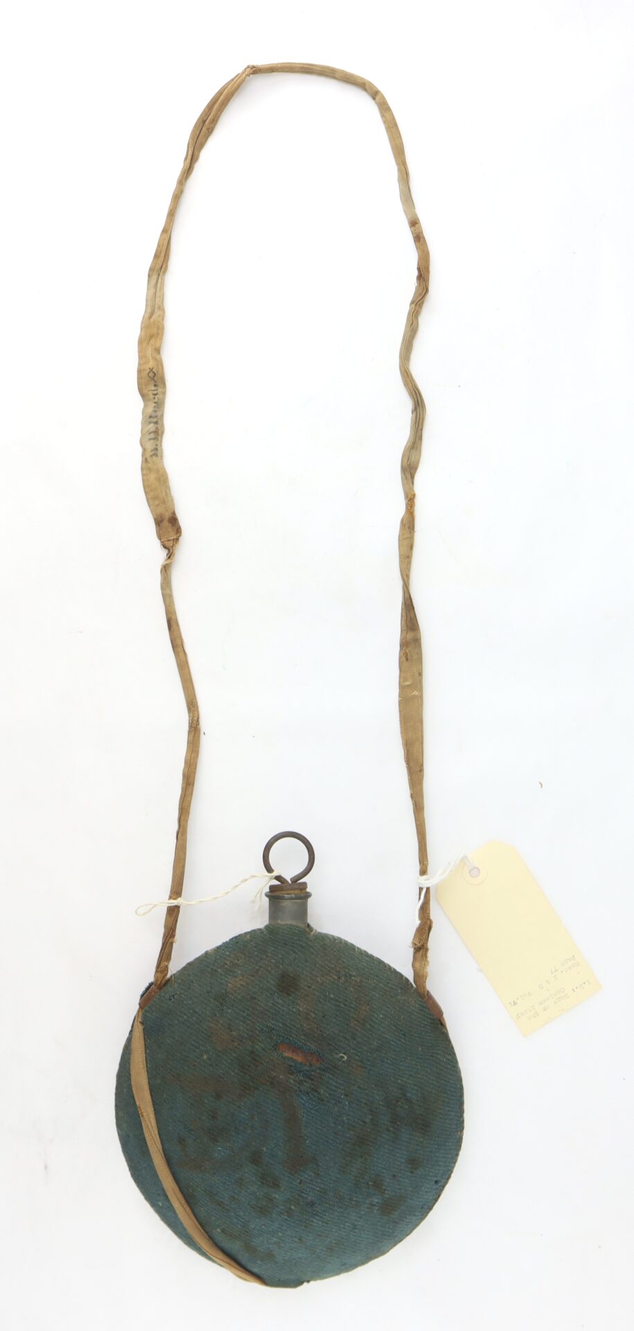 Outstanding Identified Massachusetts Heavy Artillery Canteen belonging to Benjamin D. Reed, 30th Unattached Co., Mass. Heavy Artillery, with round fabric-covered body, metal cap, worn shoulder strap, and paper tag attached.
