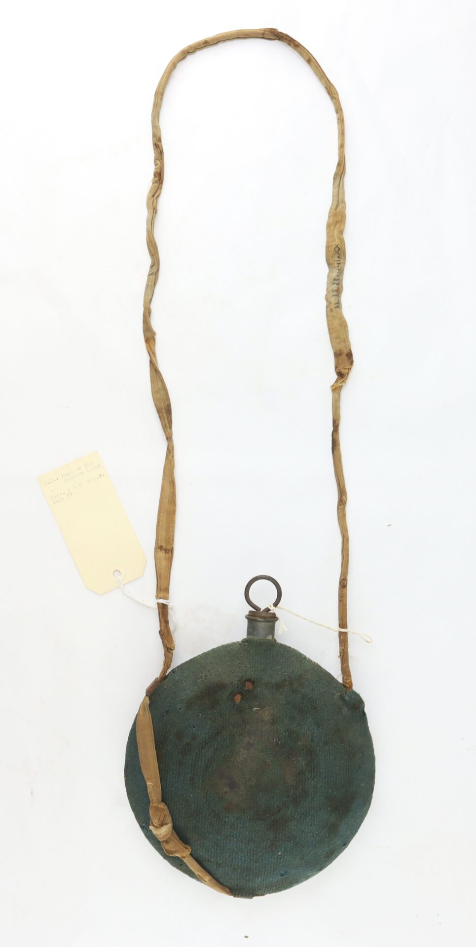 Outstanding Identified Massachusetts Heavy Artillery Canteen, carried by Benjamin D. Reed of the 30th Unattached Co., features a round shape, fabric cover and strap, metal spout, and a tag tied to the strap’s left side.