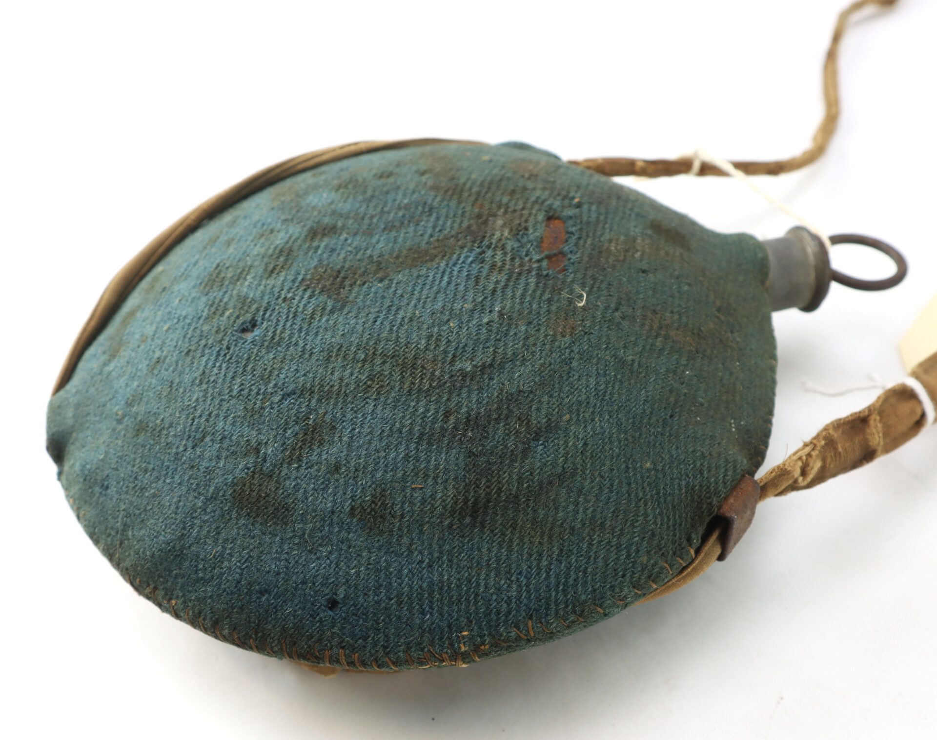 Outstanding Identified Massachusetts Heavy Artillery Canteen belonging to Benjamin D. Reed, 30th Unattached Co., Mass. Heavy Artillery; vintage, round with blue fabric cover, leather strap, metal cap, and visible wear and stains.