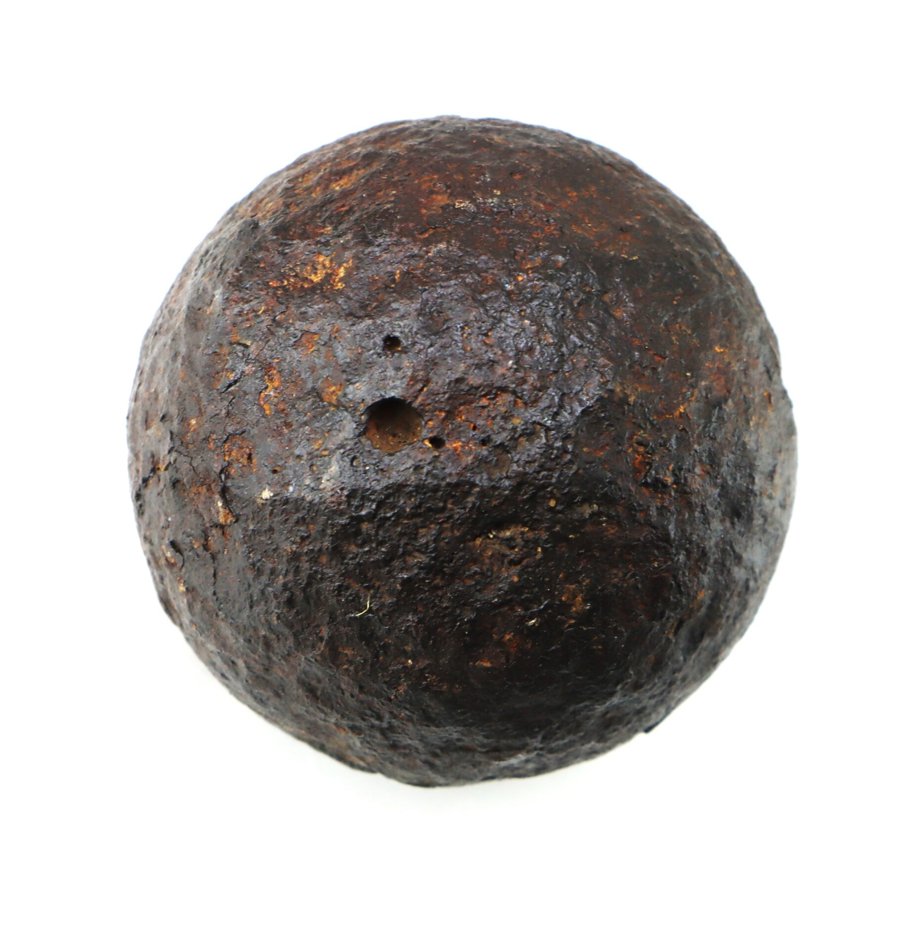 A Confederate Civil War 6-Pounder Solid Shot cannonball recovered from Bull Run, round and iron with a small hole and rough surface, photographed against a plain white background.
