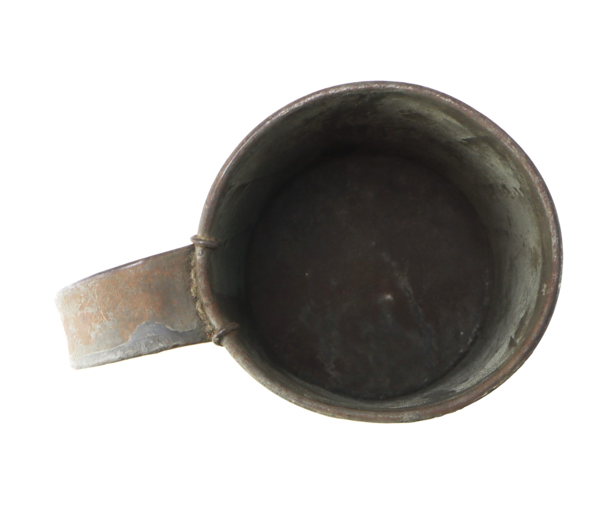 Top view of an old, empty, metal mug with visible rust and wear, placed on a white background.