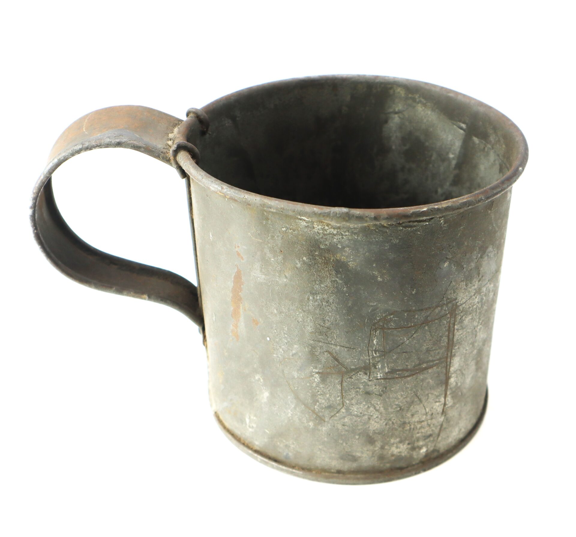 A worn, metal cup with a large handle and visible scratches and rust, photographed against a white background.