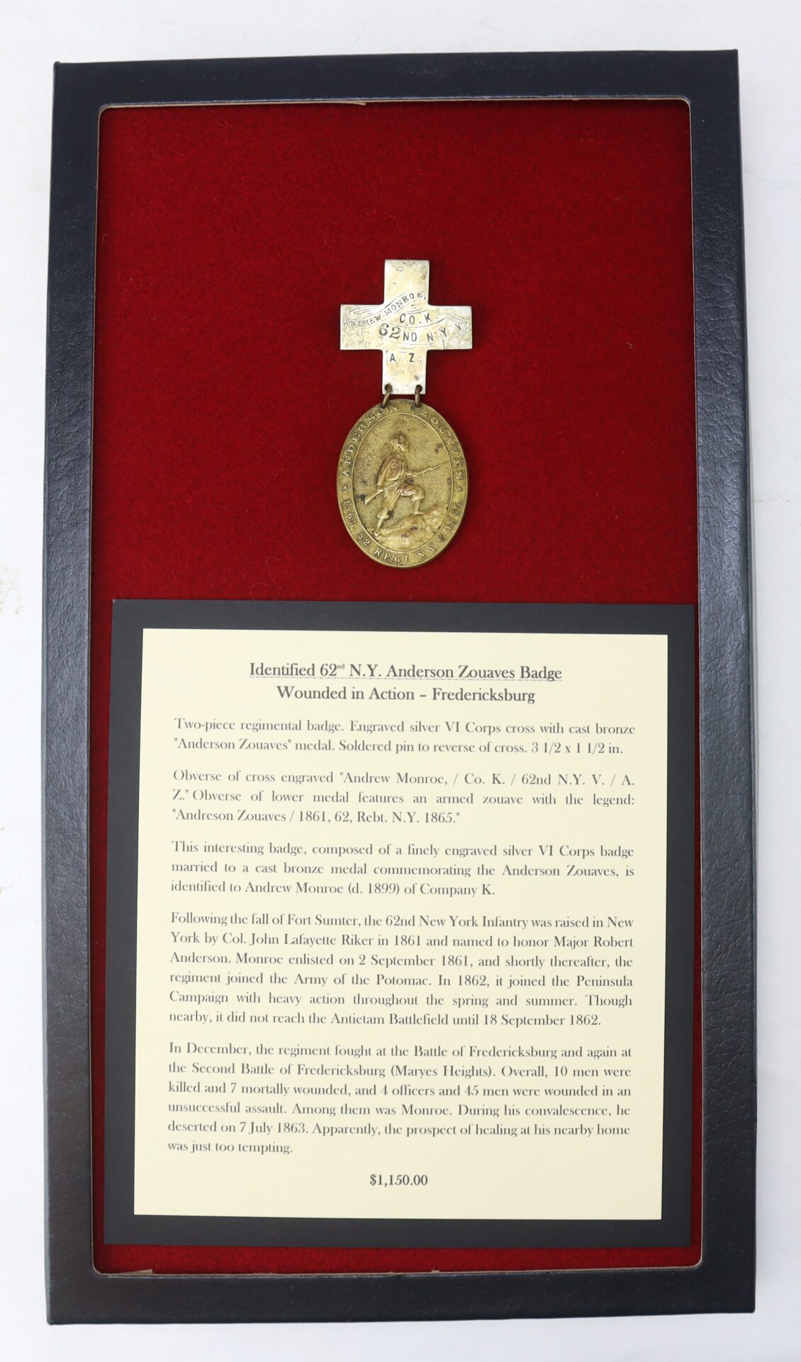 Framed 62nd N.Y. Anderson Zouaves badge with cross and medallion, displayed above an informational plaque, all mounted on red velvet within a black frame.