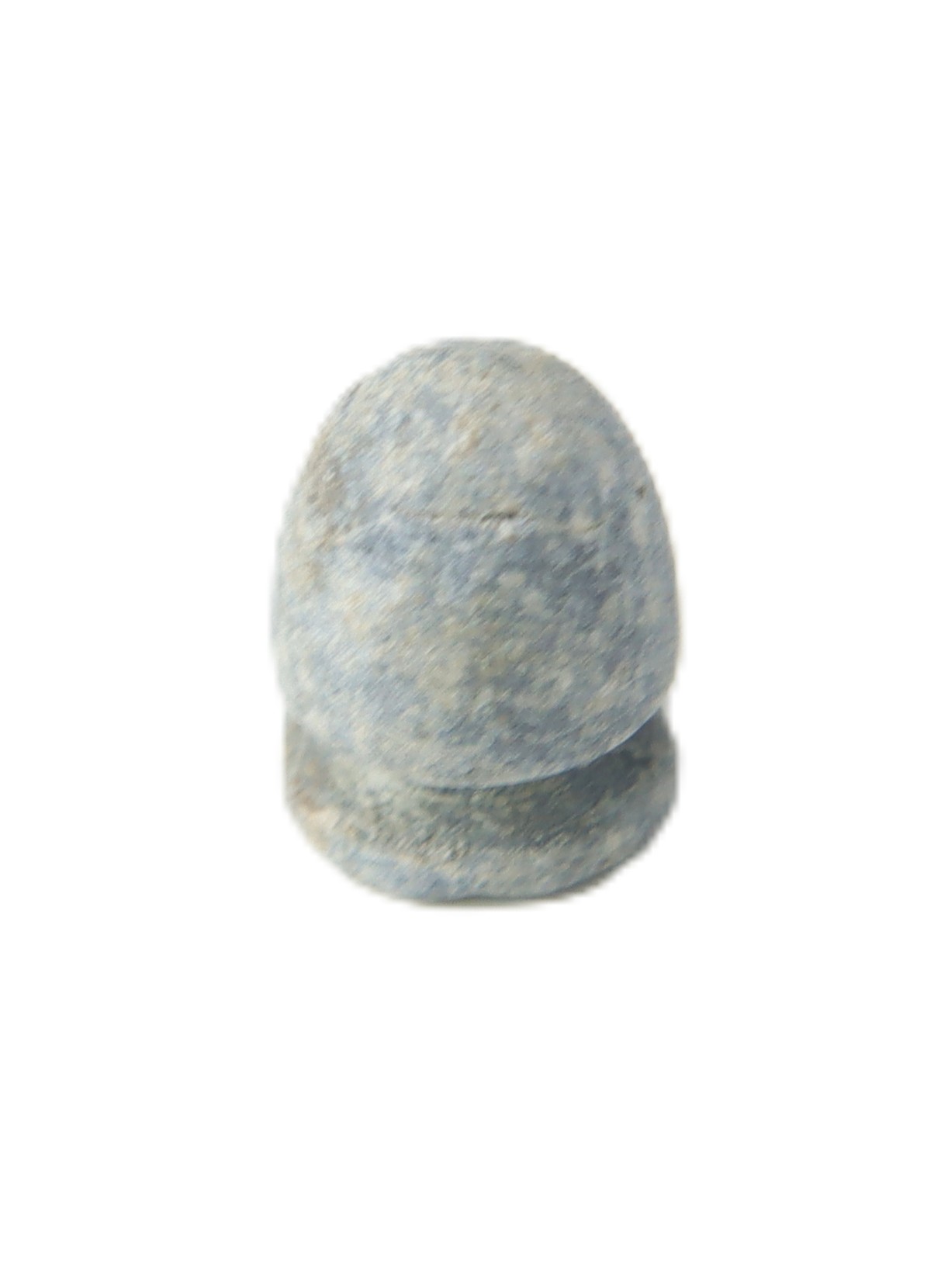 A weathered, gray, rounded object with a flat base on a white background; it resembles a small, dome-shaped stone or artifact.