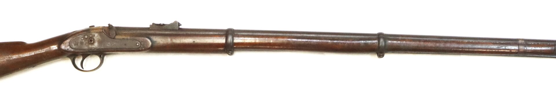 Side view of a vintage, long-barreled, double-trigger rifle with a wooden stock and metal barrel against a white background.