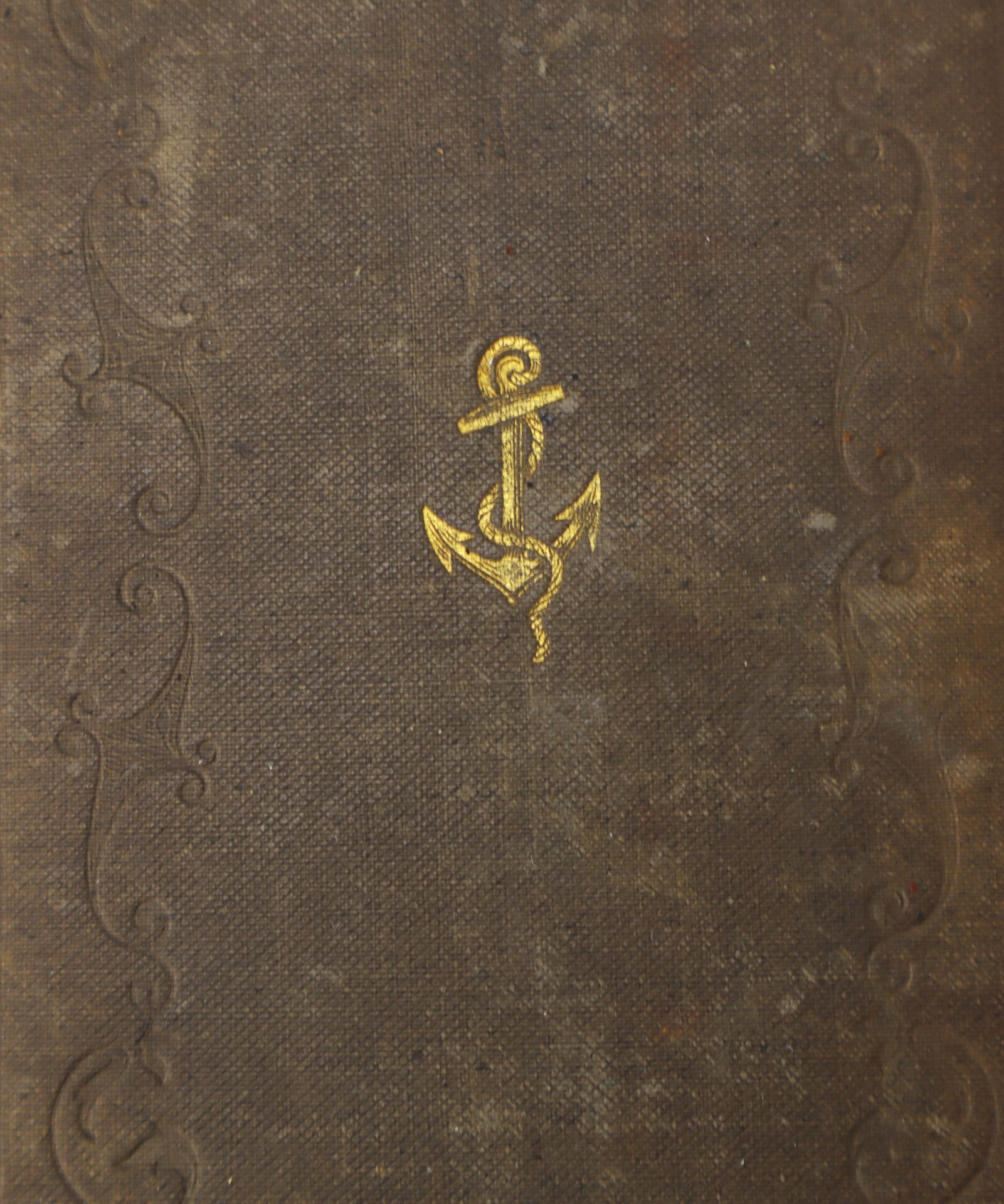 A worn, brown book cover with a gold embossed anchor symbol in the center and decorative border details.