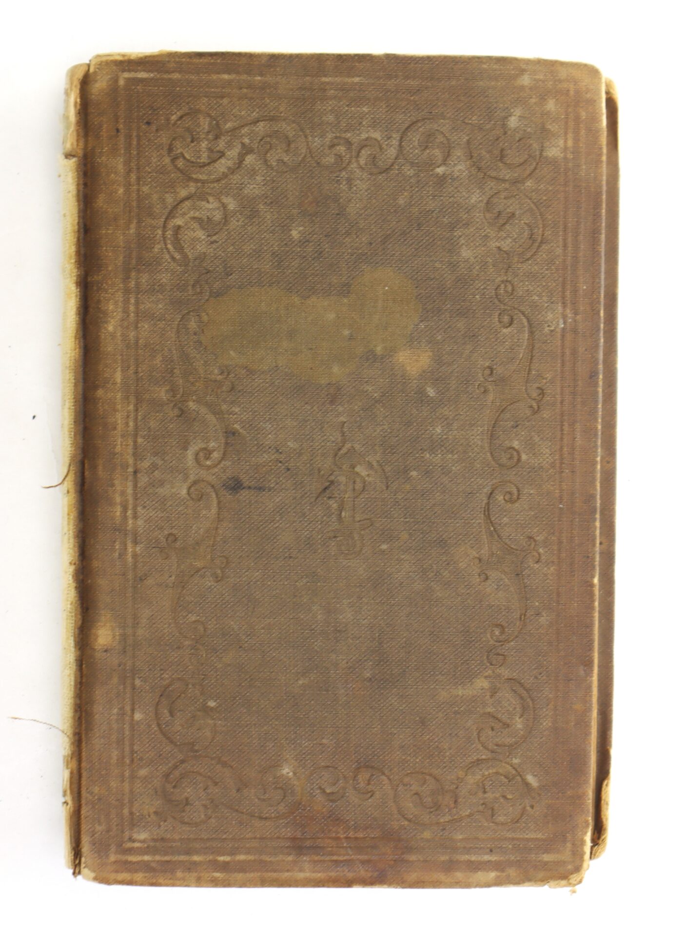 A worn, brown hardcover book with ornate embossed borders and faded areas on the cover.