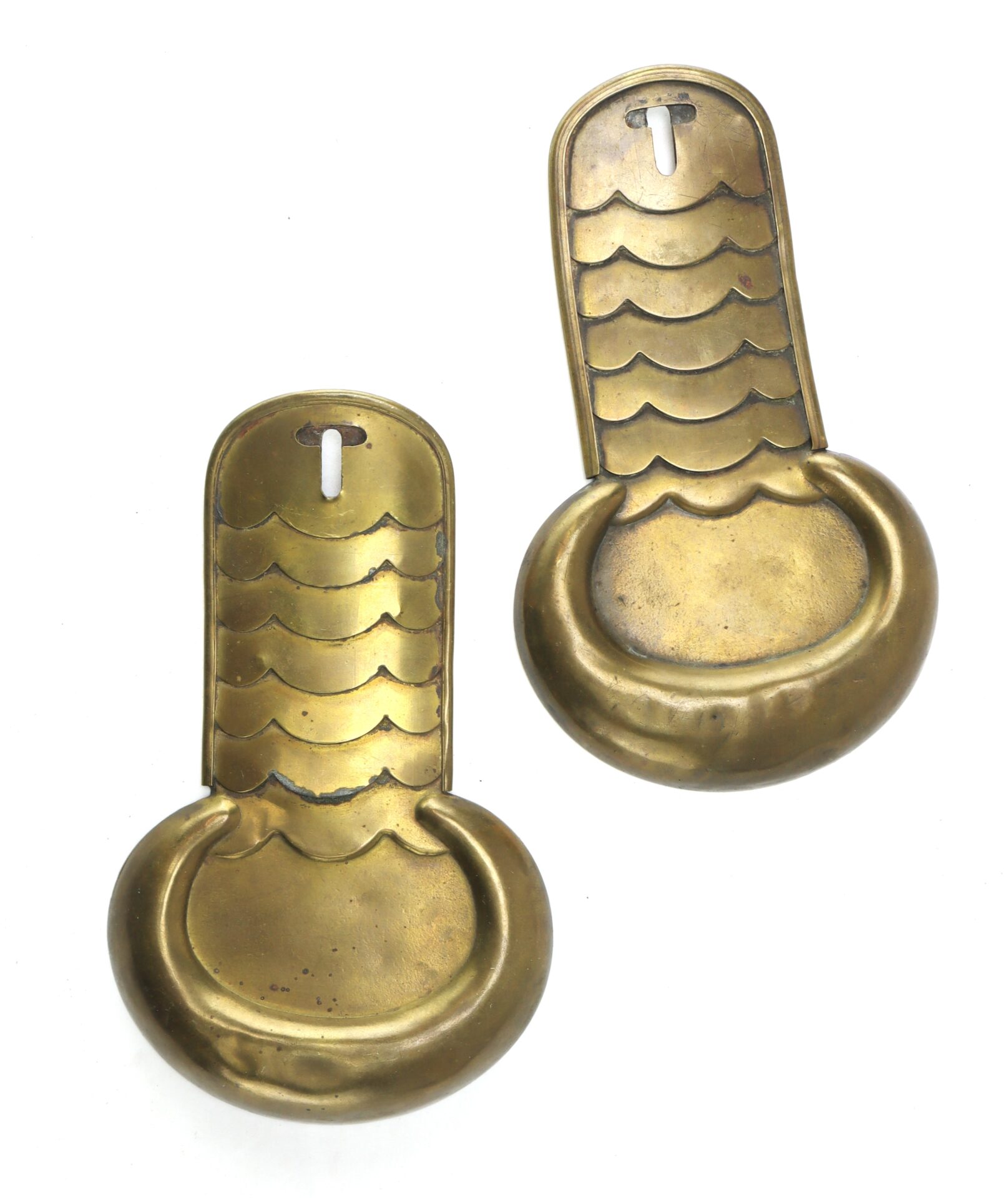 Two vintage brass door finger plates with a scalloped design and a round bottom section, each with a keyhole at the top.