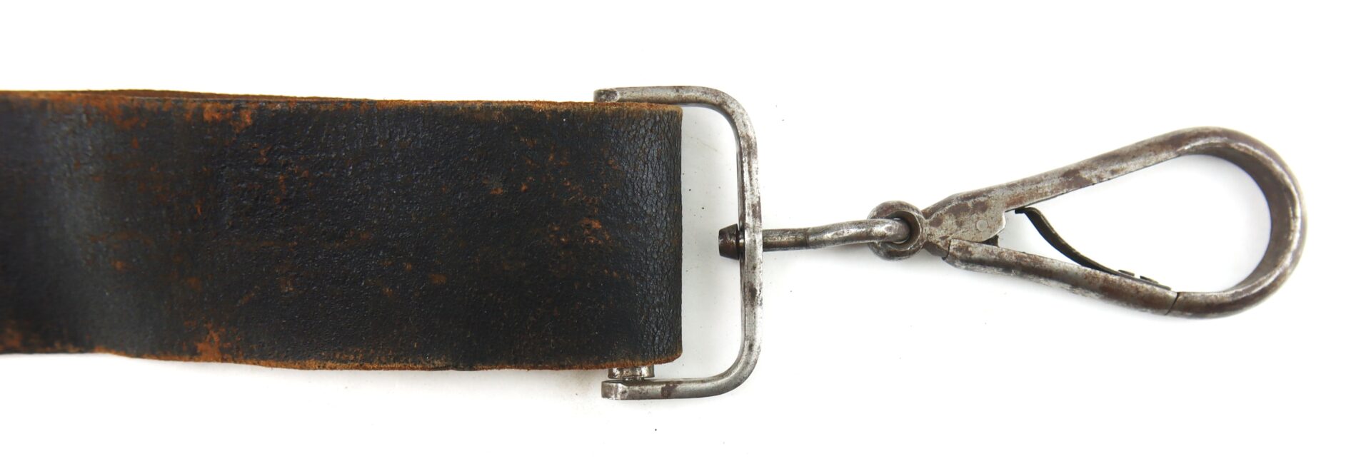 A close-up of a worn black leather strap attached to a metal swivel snap hook against a white background.