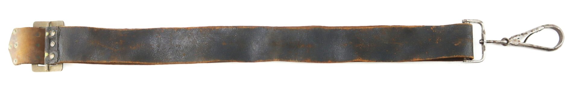 A worn, black leather strap with a metal buckle on one end and a metal clasp on the other, laid flat on a white background.
