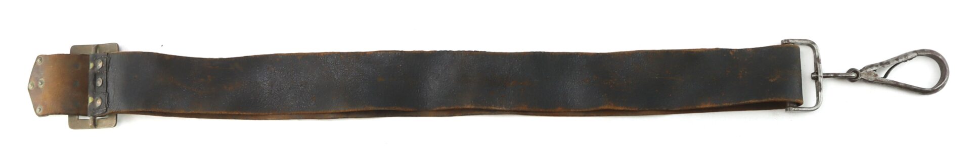 A worn black leather strap with a metal buckle on one end and a metal clasp on the other, laid out flat on a white background.