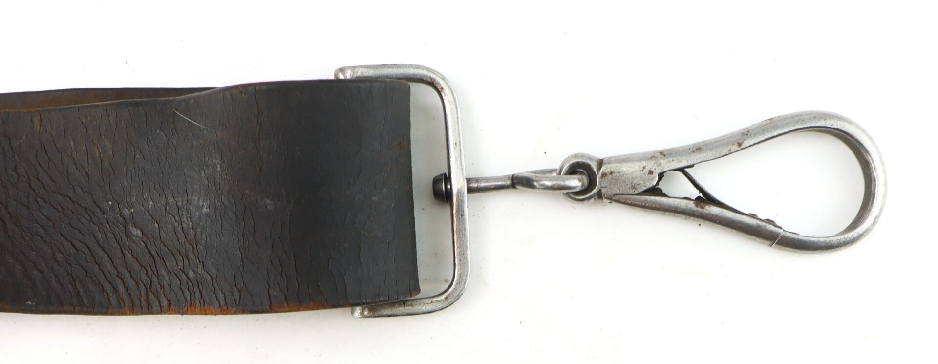 Close-up of a worn black Cavalry Carbine Sling featuring a metal buckle and silver swivel snap hook at the end, set against a white background.