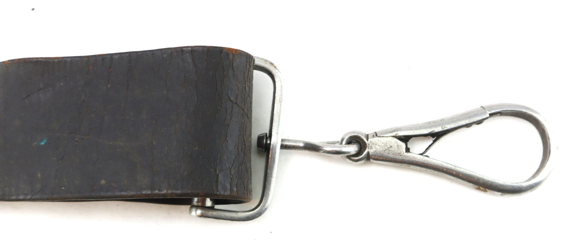 A close-up of the Cavalry Carbine Sling shows a worn, dark leather strap with a metal swivel clip on one end, set against a white background.