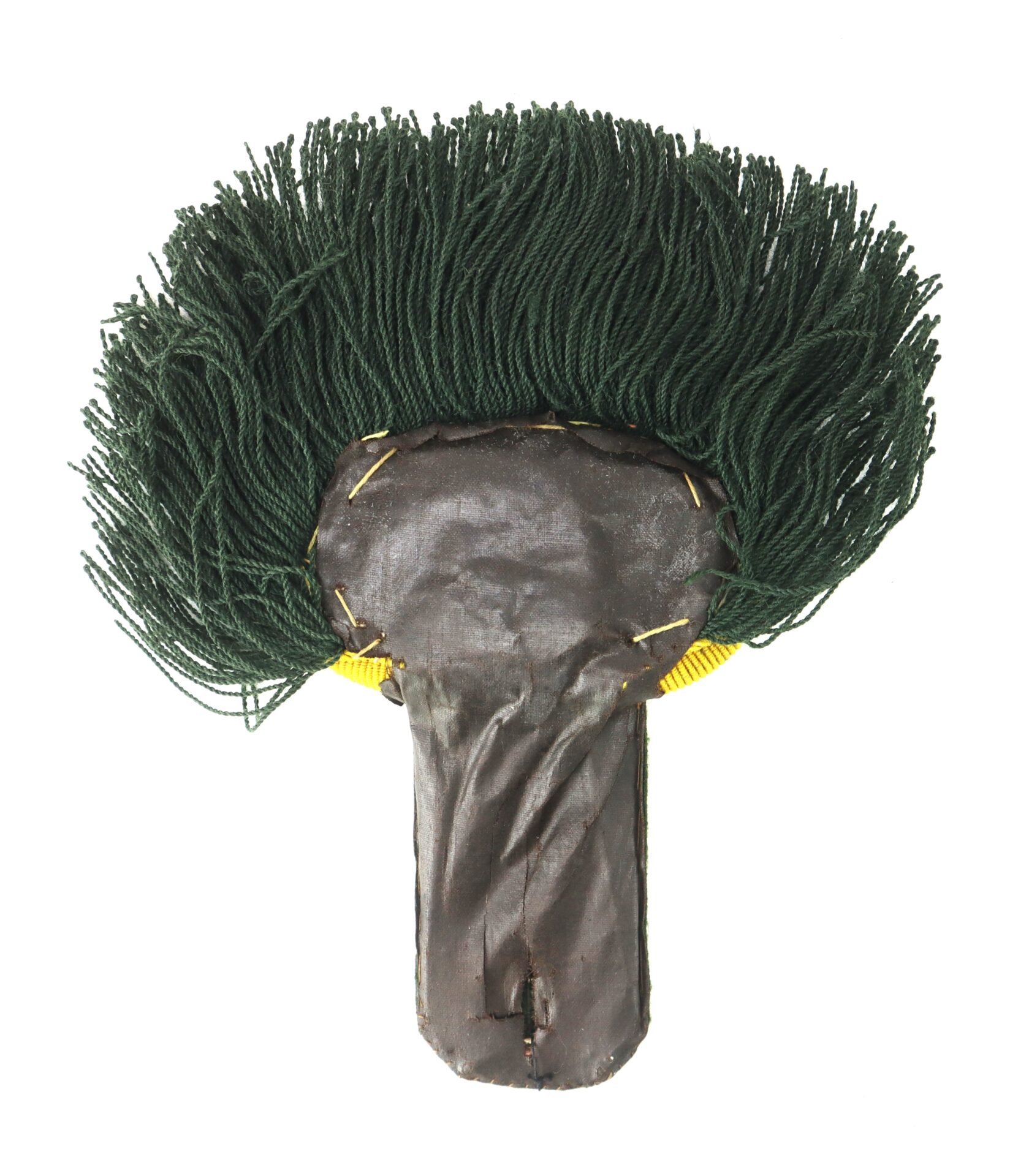 A handmade object featuring dark green yarn attached to a flat, brown, T-shaped base with visible stitching and yellow accents.