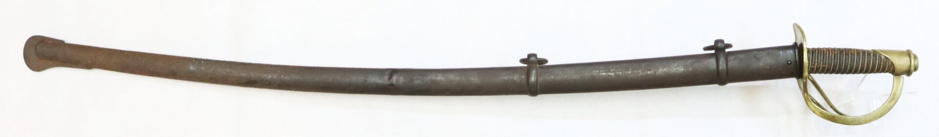 A curved sword with a metal scabbard featuring two mounting rings, a brass hilt with a knuckle guard, and a textured grip.