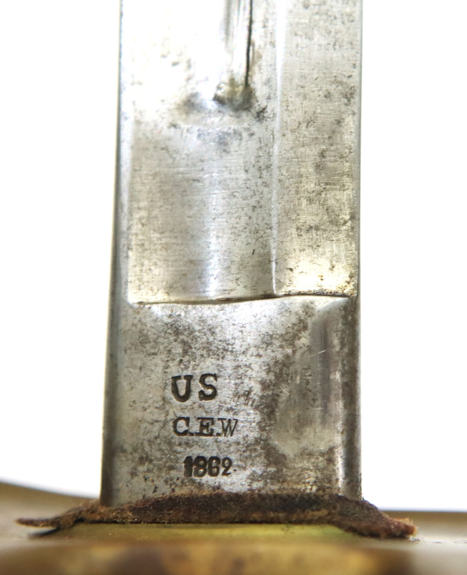 Close-up of a metal blade with the inscription "US", "CLEW", and "1862" engraved near the hilt.