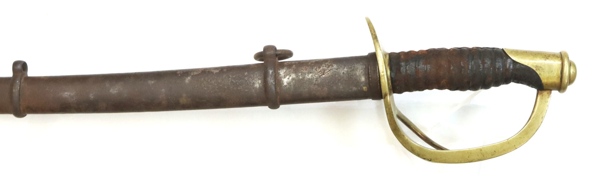 A rusted sword with a brass guard and a worn handle, partially sheathed in a metal scabbard, displayed on a white background.