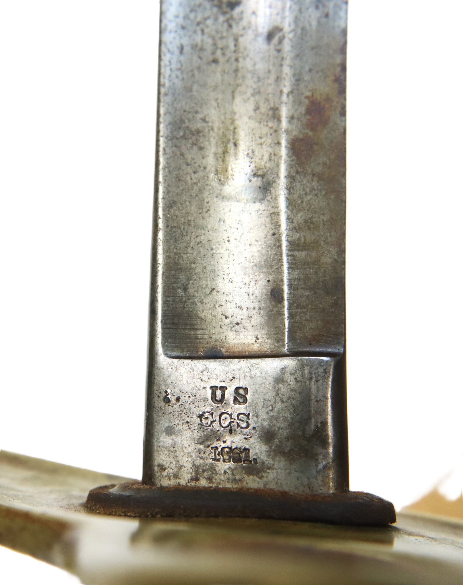 Close-up of a metal blade with stamped markings reading "U.S. C&GS 1861" on the flat near the guard, against a plain white background.