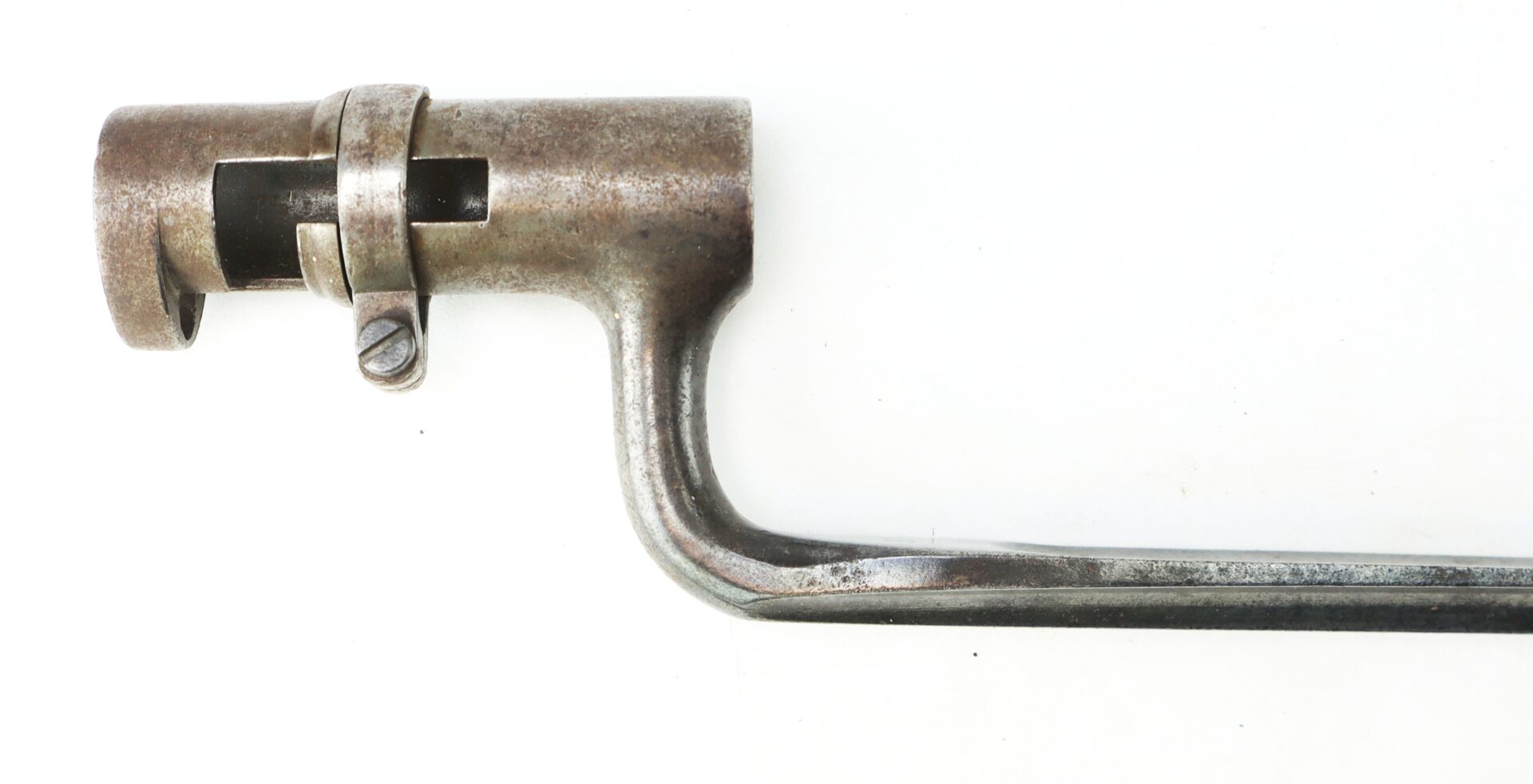 Close-up of a Model 1855 .58 Caliber Triangular Socket Bayonet featuring a vintage metal design with cylindrical attachment and curved mounting arm.