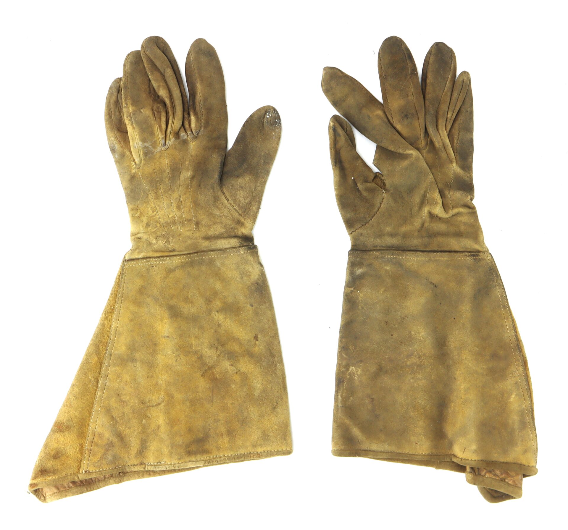 A pair of worn, brown leather gloves with extended cuffs, laid flat on a white background.
