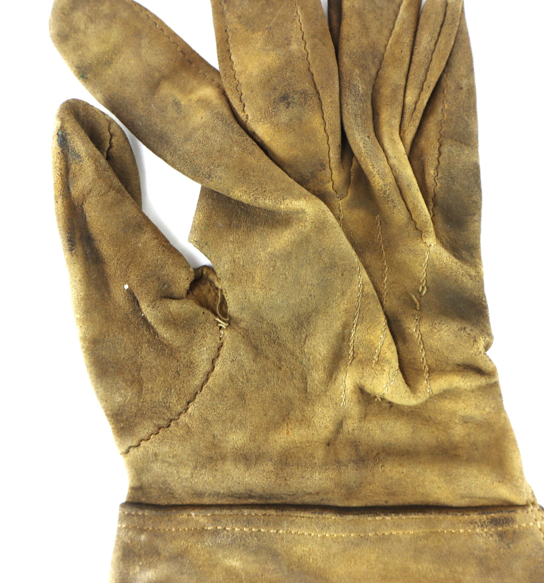 A worn, brown leather glove with visible creases and stains is shown against a white background.