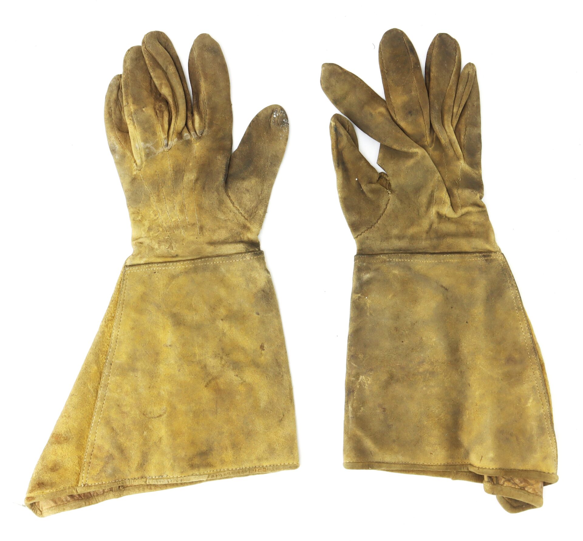 A pair of worn, brown leather gloves with extended cuffs displayed on a white background.