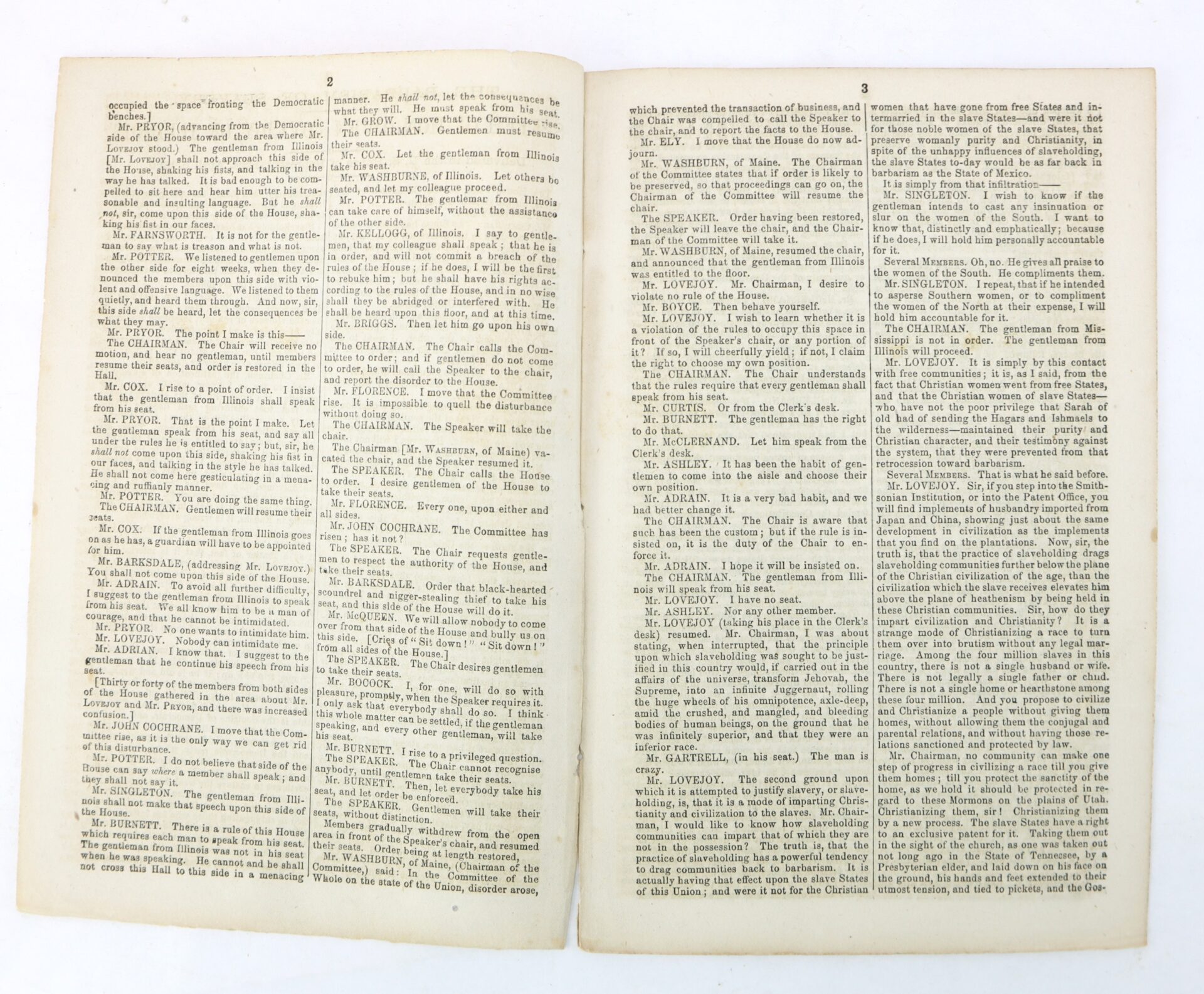 An open book displaying two pages of densely printed text in three columns, with parliamentary or meeting dialogue and speaker names in small, serif font.