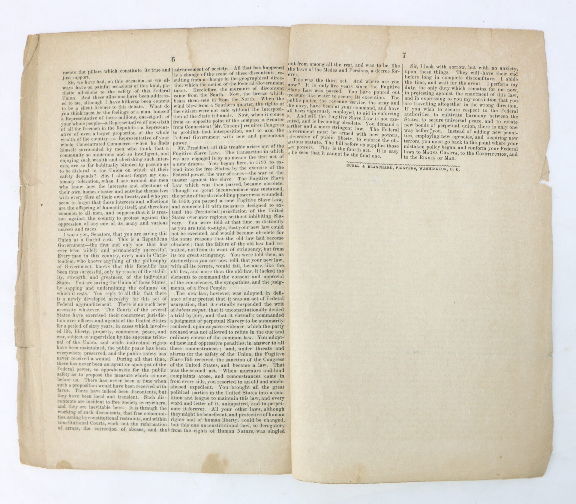 An open, aged book displaying two yellowed pages filled with dense, small printed text arranged in two columns on each page.