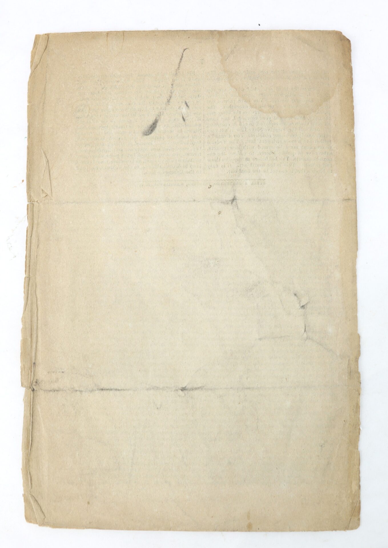 A worn, yellowed sheet of paper with creases, stains, and faded text, lying on a white background.