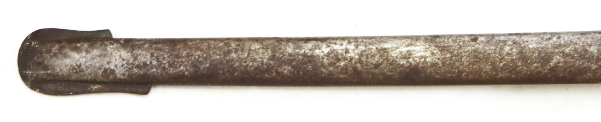 A close-up of a rusted, metal cylindrical object with a flattened, spade-shaped end against a white background.