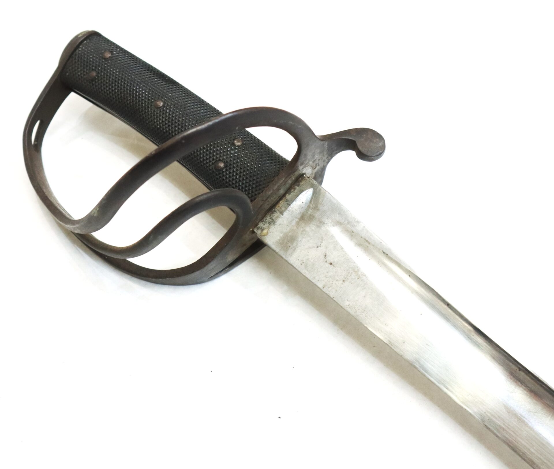 A close-up of a sword with a black textured grip and a protective metal handguard, shown against a white background.