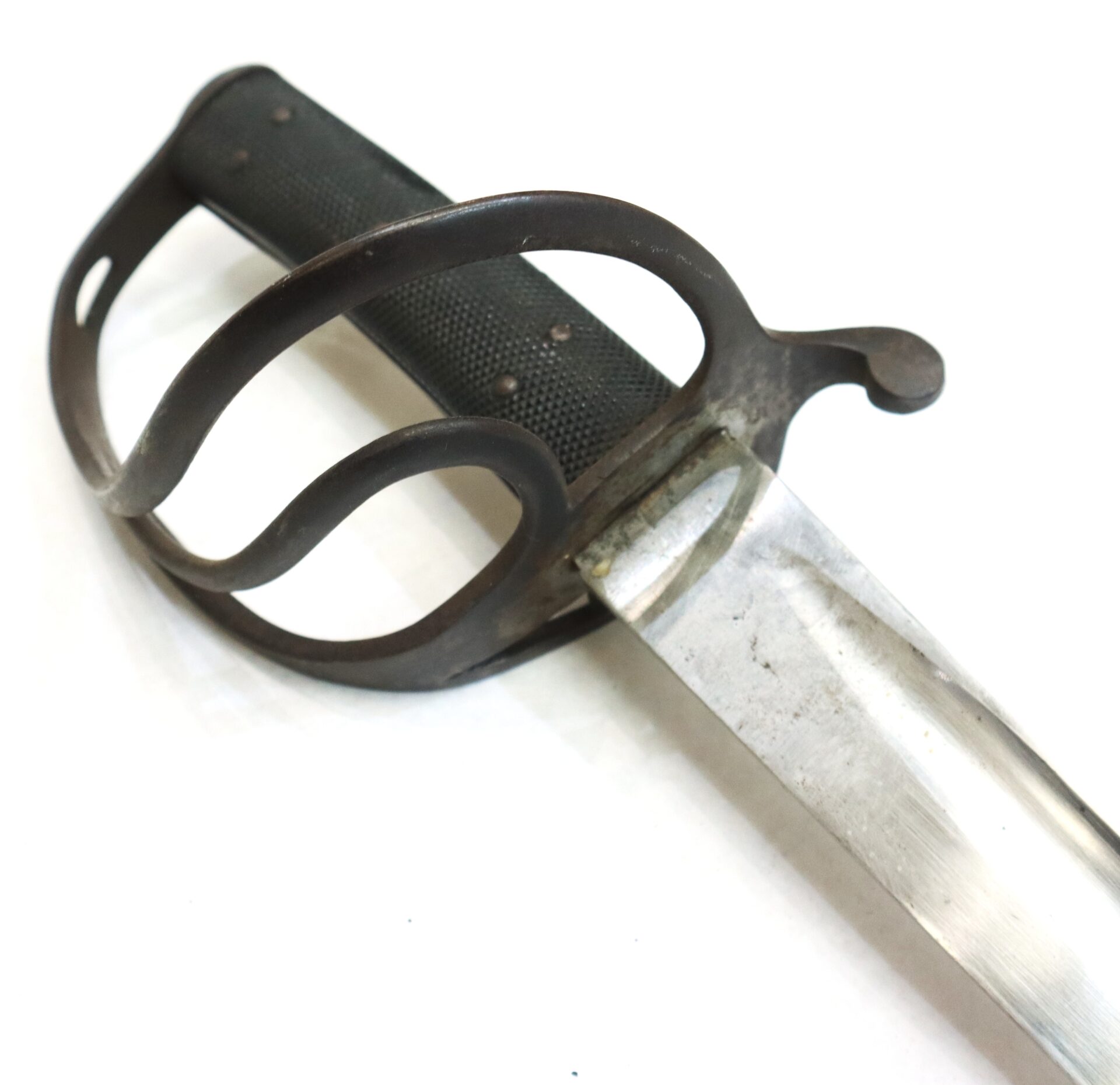 A close-up view of a sword with a black textured grip, metal handguard, and a partially visible silver blade on a white background.