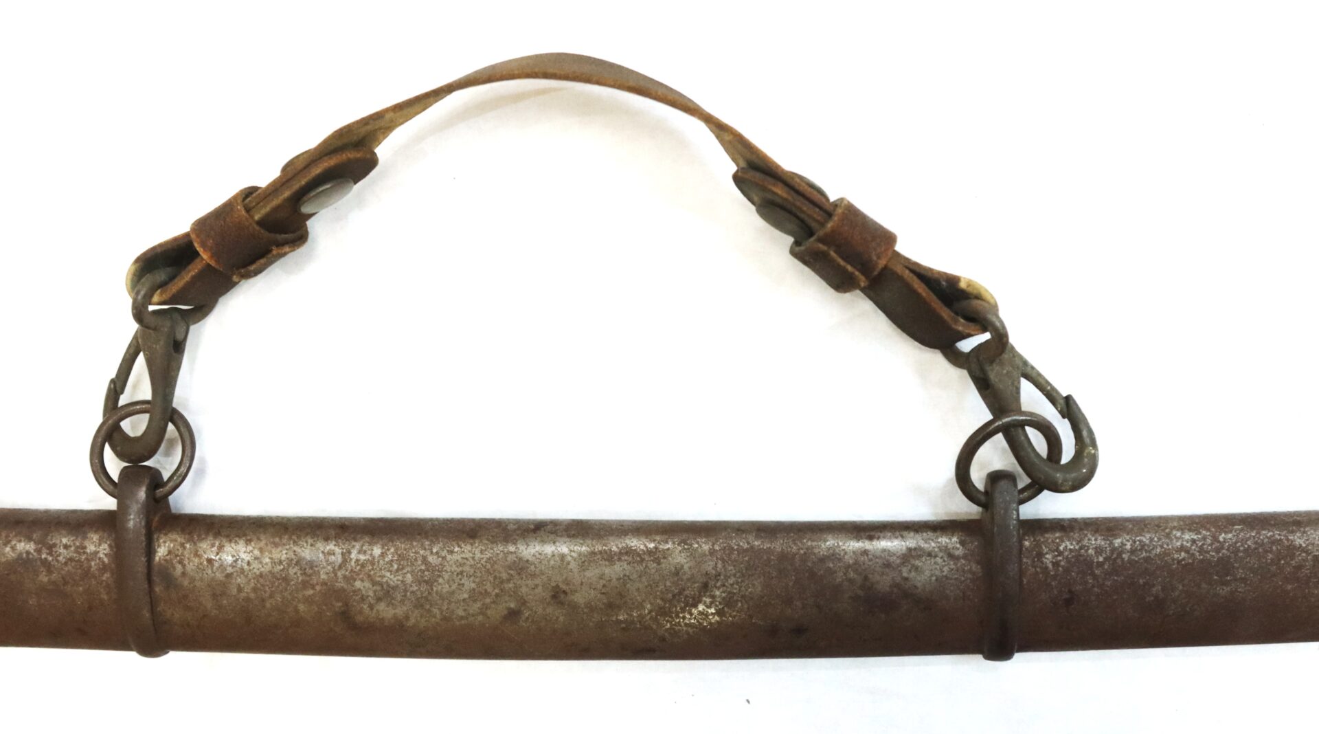 A weathered metal bar with a worn leather strap and metal clips attached on each end, set against a white background.