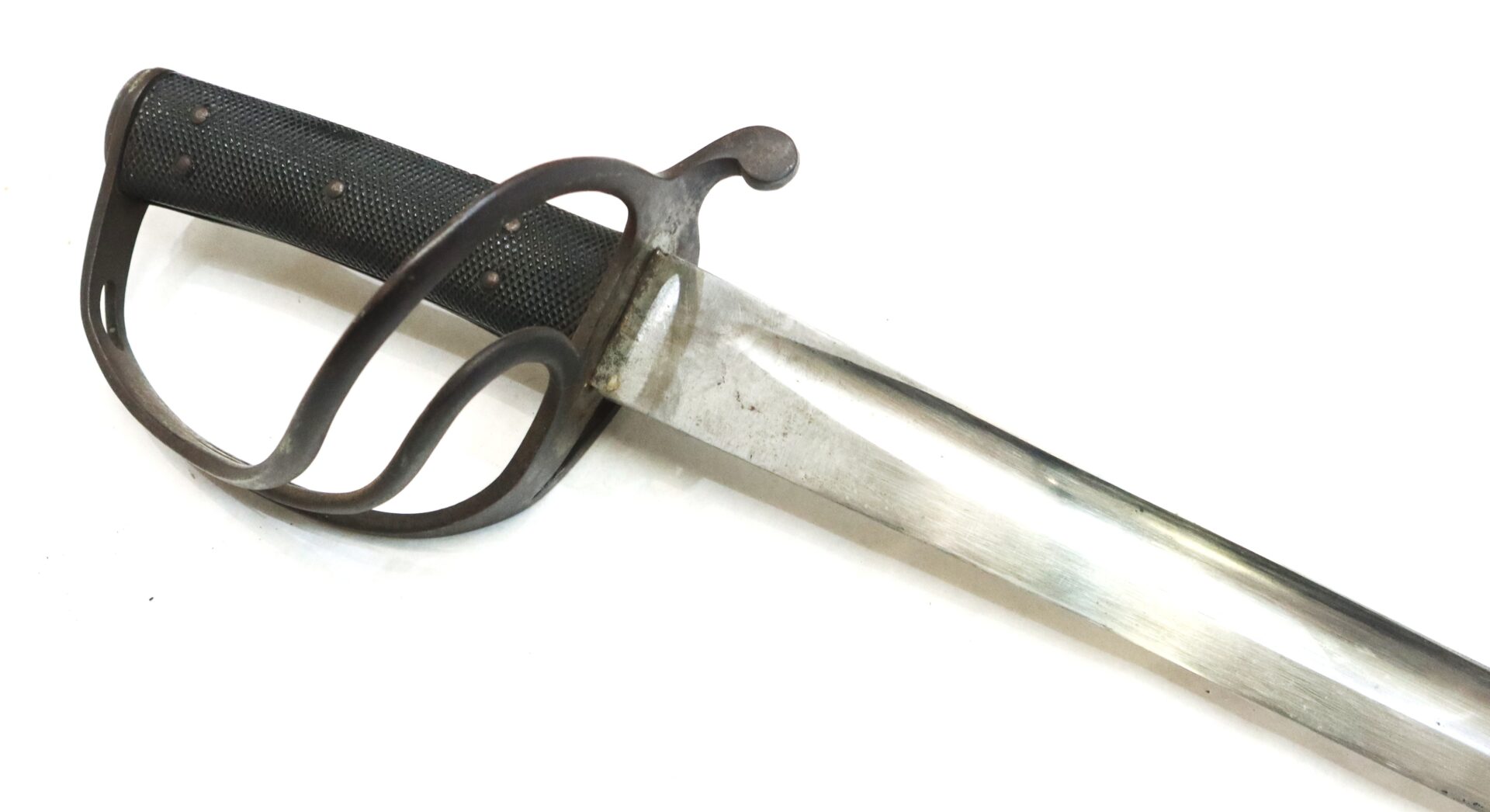 A close-up of an antique sword with a metal guard and a textured black handle, set against a white background.