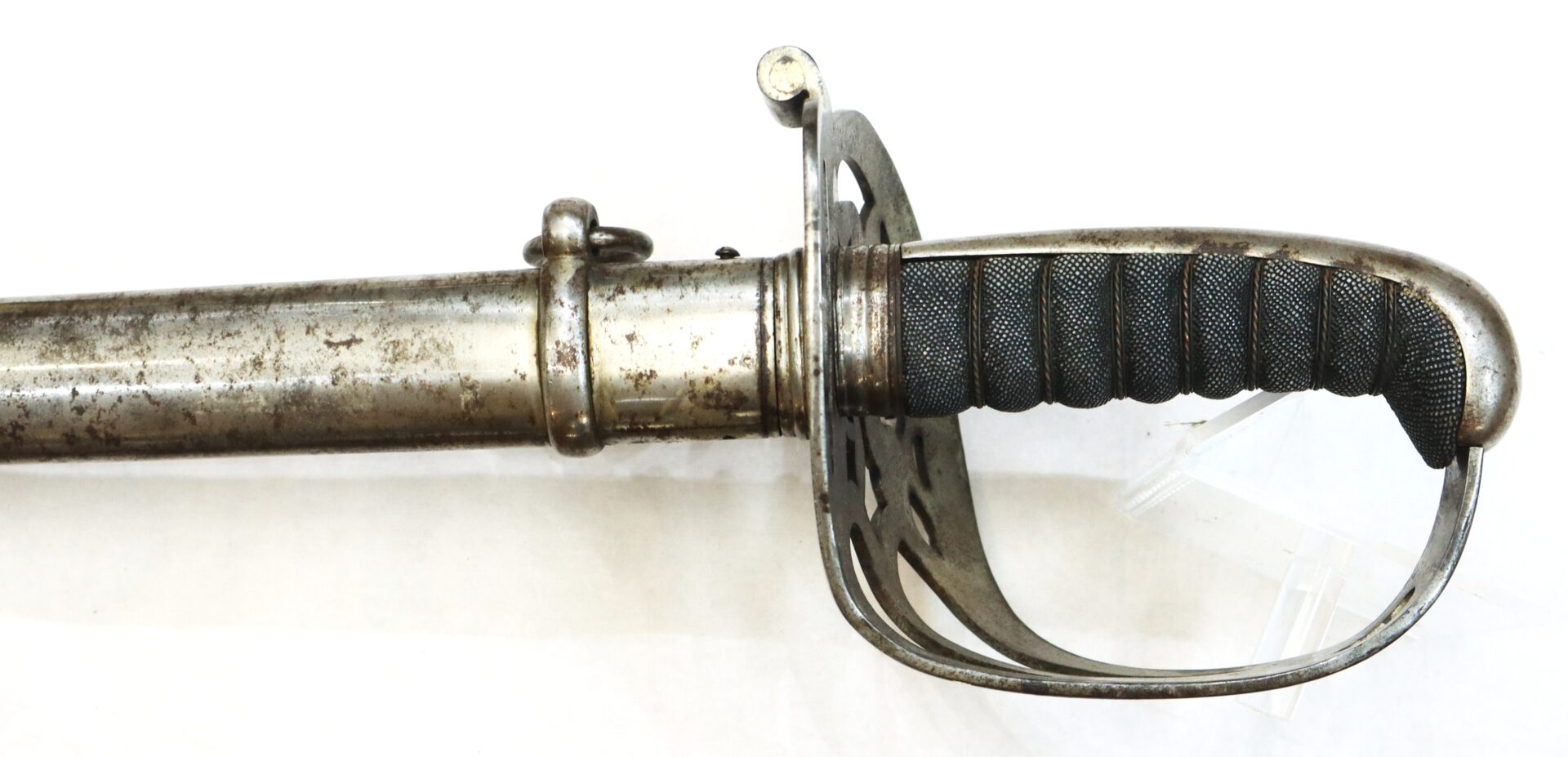 A close-up of an antique military sword with a metal guard and black-wrapped handle, partially sheathed in a metal scabbard.