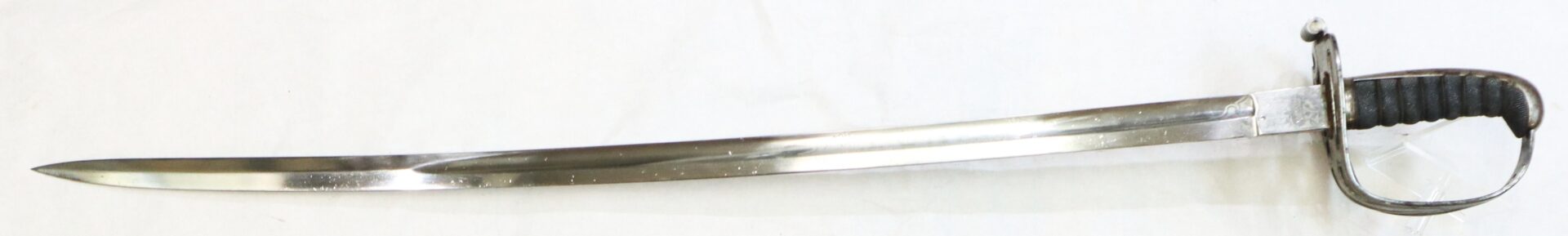 A curved, single-edged sword with a black ridged handle and a metal guard, displayed on a white background.