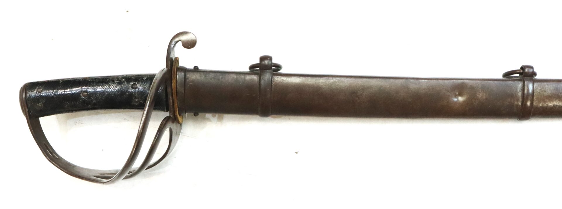 A vintage cavalry sword with a black grip and metal guard, partially sheathed in a worn metal scabbard with two suspension rings, shown on a white background.