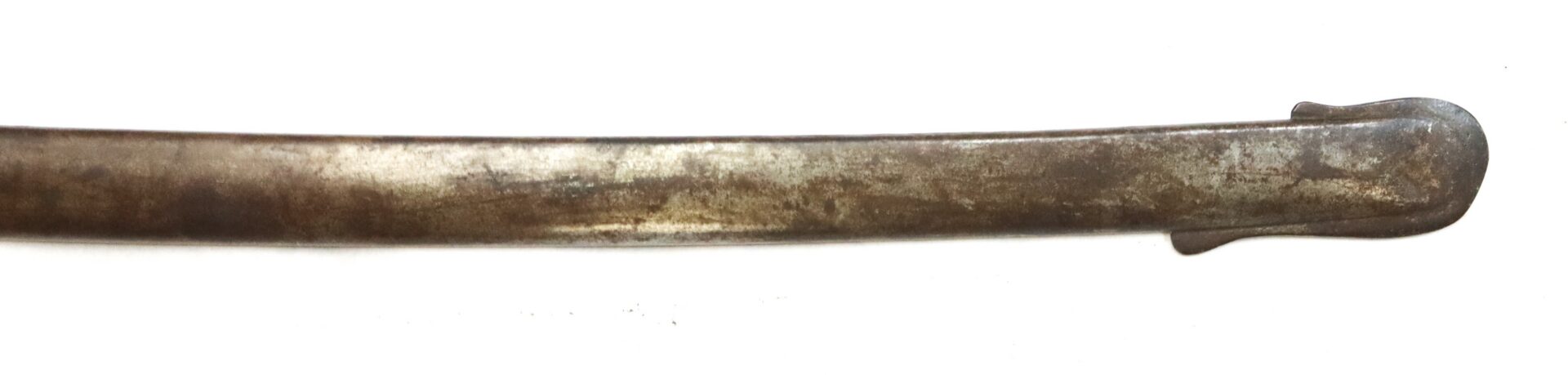 A close-up of an old, slightly curved metal sword blade with a rounded tip against a white background.