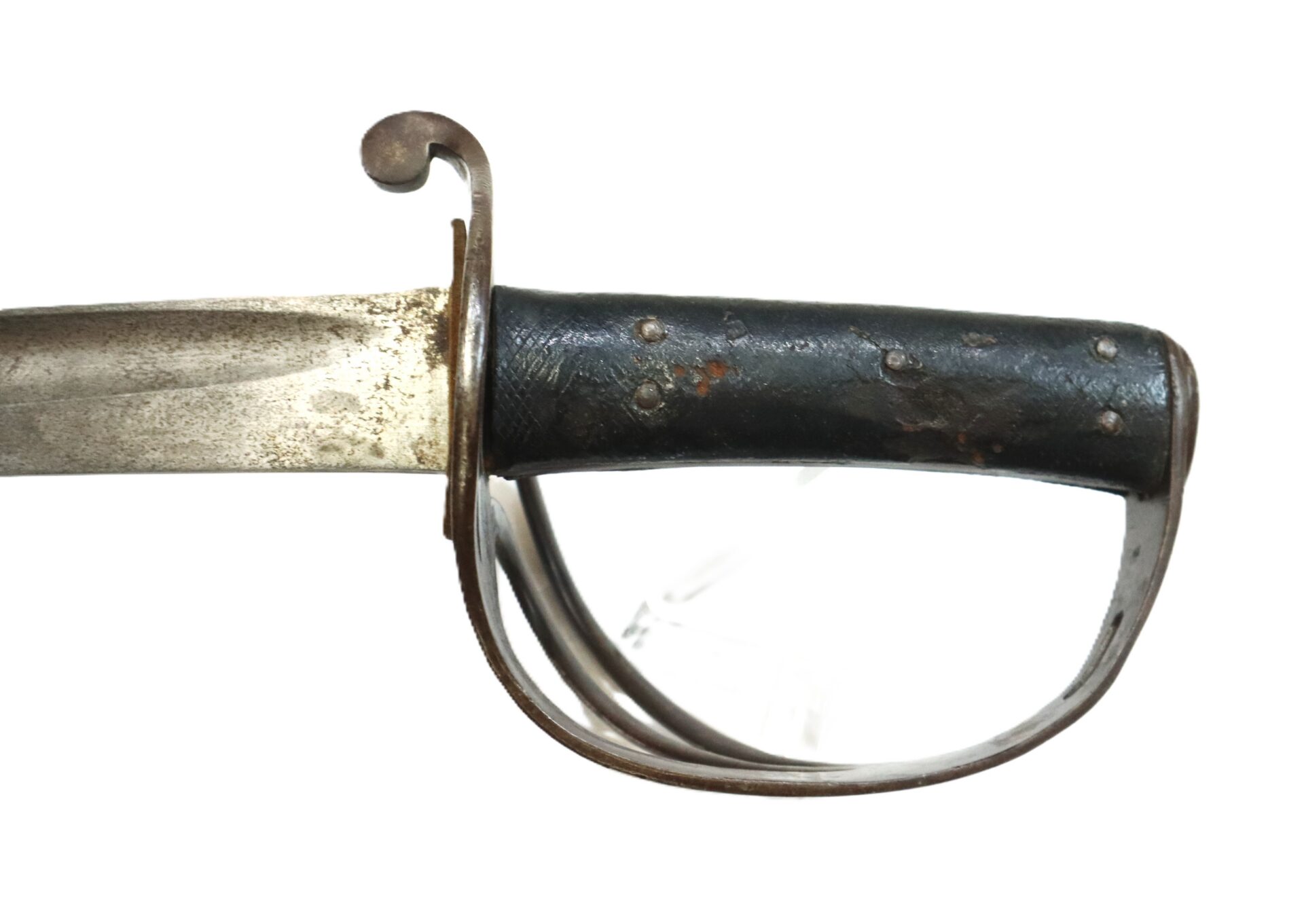 Close-up of a vintage sword hilt with a black grip, metal guard, and a partially visible, slightly tarnished blade against a white background.