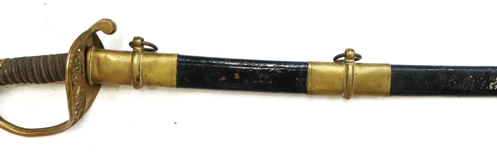 Close-up of a vintage sword with a wrapped handle, brass guard, and black scabbard featuring brass fittings and suspension rings, set against a white background.