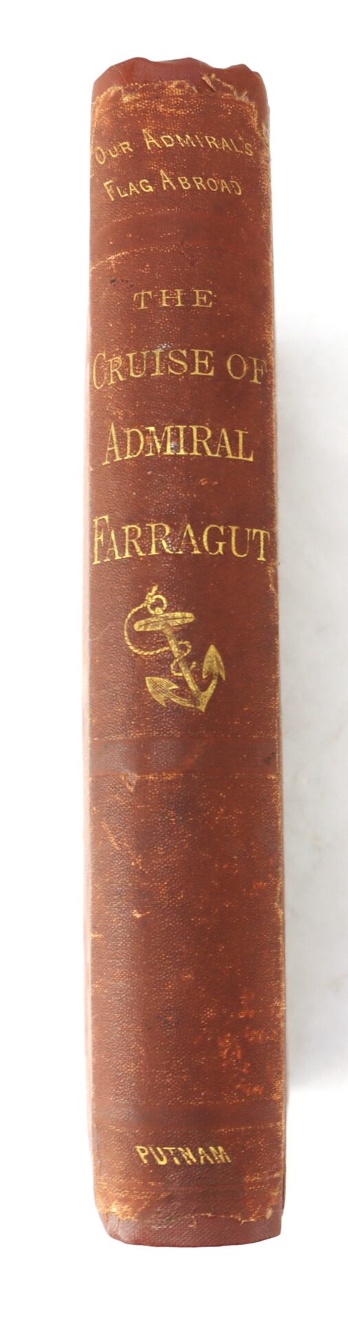 The spine of a worn red book titled "The Cruise of Admiral Farragut" with gold lettering and an anchor illustration, published by Putnam.