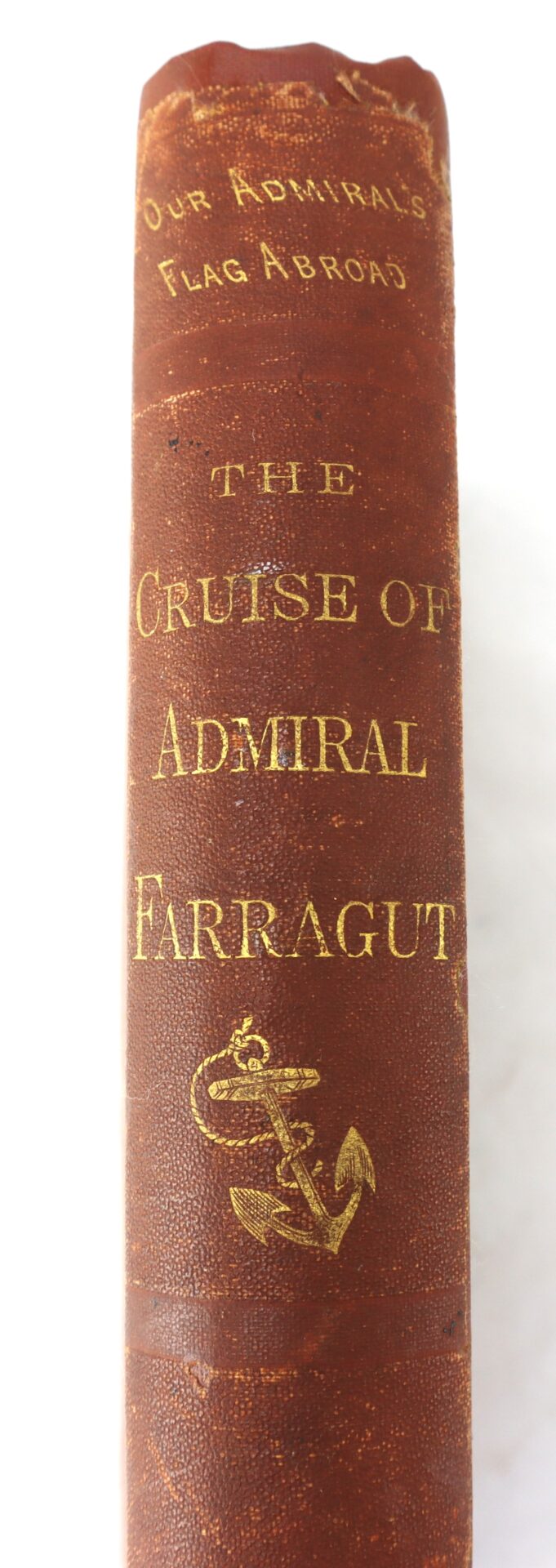 Spine of an old book titled "The Cruise of Admiral Farragut" with a gold anchor illustration and the subtitle "Our Admiral's Flag Abroad.